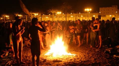 Spaniards celebrate San Juan festival with beach bonfires.